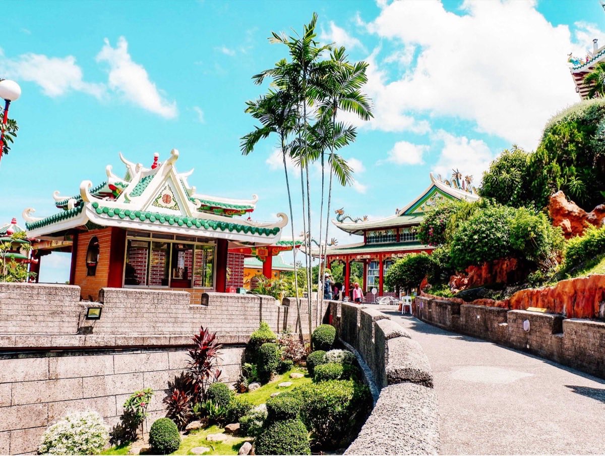 Pagoda Near Tall Trees Under Blue Sky